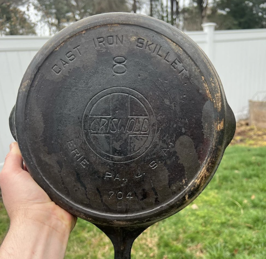 vintage cast iron skillet with minor rust, iron guards